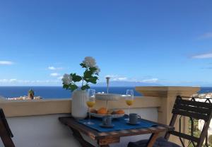 a table with two glasses of wine on a balcony at Dream View in Adeje