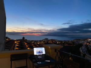 a balcony with a view of a city at night at Dream View in Adeje