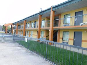 a building with a fence in front of it at Camilla Inn & Suites in Camilla +22 photos