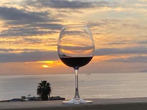 a glass of wine sitting on the beach with the sunset at Dream View in Adeje