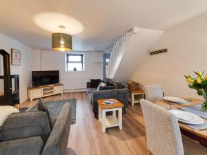 a living room with a couch and a table at 2 Ysgoldy in Bangor