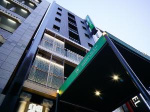 um sinal de rua em frente a um edifício alto em Nagoya Sakae Green Hotel em Nagoia