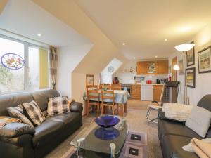 a living room with a couch and a table at The Apartment in Croy