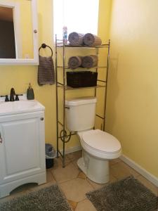 a bathroom with a white toilet and a sink at Dolan Springs, Grand Canyon Skywalk in Dolan Springs +12 photos