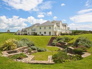 a large house on a hill with a garden at Horizon in Kingsbridge