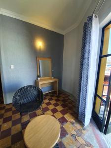 a room with a table and a table and a mirror at Hotel Rivera in Oaxaca City