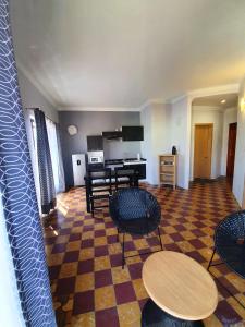 a living room with tables and chairs and a piano at Hotel Rivera in Oaxaca City