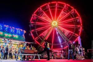 a ferris wheel at a carnival at night at Cozy 1-BDR Suite #20 by Amazing Property Rentals in Gatineau