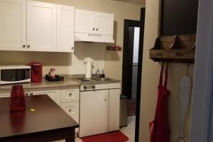 a kitchen with white cabinets and a counter top at Cozy 1-BDR Suite #20 by Amazing Property Rentals in Gatineau