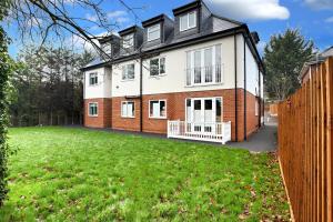 a large house with a yard in front of it at Braywick Serviced Apartments by Ferndale in Maidenhead