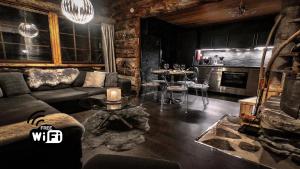 a living room with a couch and a table at Ruka Chalet Petit Oliver in Ruka