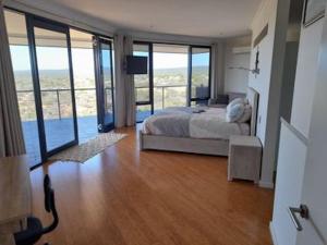 a bedroom with a bed with a view of the ocean at Eco Haven retreat in Kalbarri