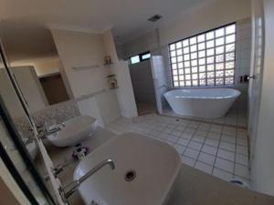 a bathroom with a sink and a tub and a toilet at Eco Haven retreat in Kalbarri