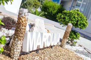 a sign for a yard with trees and rocks at Maroula Studios in Faliraki