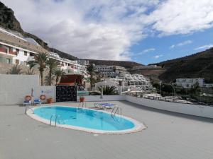 a swimming pool on the roof of a resort at Marianela Apartment in Puerto Rico de Gran Canaria