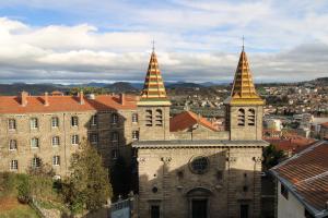 an old building with two towers on top of it at Les Cimes du Puy-en-Velay in Le Puy-en-Velay