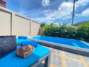 a patio with a blue table and a swimming pool at Blue Aura Pool Villa in Nai Yang Beach