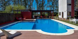 a swimming pool in a backyard with a wooden deck at Aires del Norte in Federación