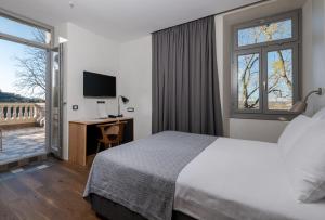 Ένα ή περισσότερα κρεβάτια σε δωμάτιο στο Hotel Peteani