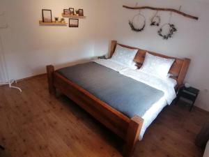 ein Schlafzimmer mit einem Holzbett mit weißen Kissen in der Unterkunft Apartment Kieselsgrund in Dielheim