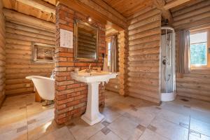 a bathroom with a sink and a bath tub at Alauso Slenis in Sudeikiai +44 photos