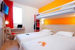 Llit o llits en una habitació de Première Classe Roissy - Aéroport CDG - Le Mesnil-Amelot