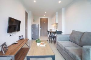 a living room with a couch and a table at De Amber Bang Sarae by FunnyProperty in Bang Sare