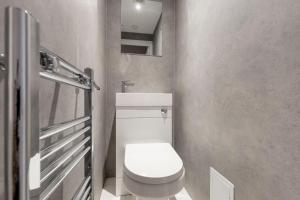a small bathroom with a toilet and a sink at innerCityLets - Royal Mile in Edinburgh