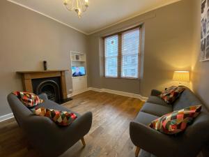 a living room with two couches and a fireplace at innerCityLets - Royal Mile in Edinburgh