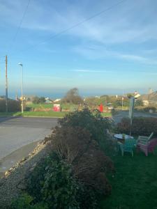 two benches sitting on the side of a road at Green Apple Bed and Breakfast in St Ives