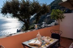 a table with a view of the ocean on a balcony at Hotel Villa Gabrisa in Positano
