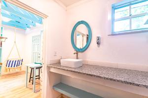 a bathroom with a sink and a mirror at Studio Candy at Viking Hill - Love Beach in Nassau +14 photos