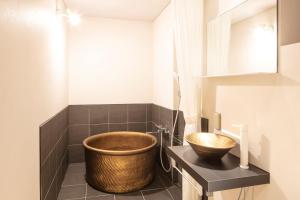 a bathroom with a large wooden bowl on a counter at Tanakaya Kyoto Karasuma in Kyoto