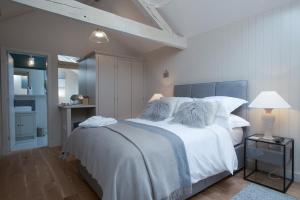 a bedroom with a large bed with white sheets and pillows at Stownes in Stow on the Wold