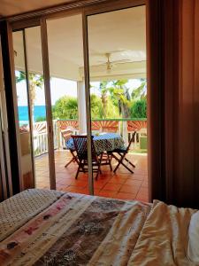 a bedroom with a bed and a view of the ocean at Le coup de coeur in Saint-François