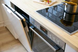 a stove in a kitchen with a wooden counter top at Apartment in musikalischem Haus in Mayen