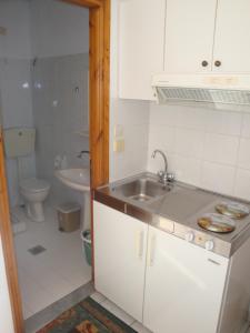 a small bathroom with a sink and a toilet at Filaktos Studios in Skala Sotiros