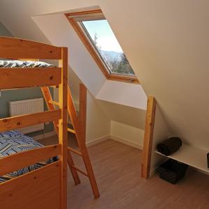 a room with two bunk beds and a window at Aux chataigniers alpins in Gap