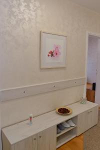a shelf in a room with a plate of cookies at Apartman Vukovic in Valjevo