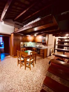 a large kitchen with a wooden table and chairs at Hesperia Apartment in Treviso