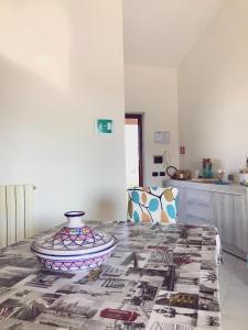 una mesa de comedor con un jarrón encima en Domus Afrodite en Anzio