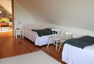 1 Schlafzimmer mit 2 Betten, einem Tisch und Stühlen in der Unterkunft Brösarps Norra Backar in Brösarp