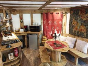 a small kitchen with a table and a stove at Le Coeur De La Foret in Pierrefonds