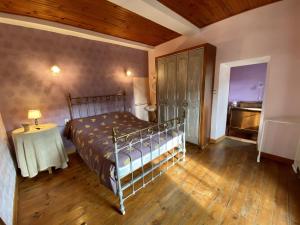 a bedroom with a bed and a table in it at Château Villemagne in Lagrasse