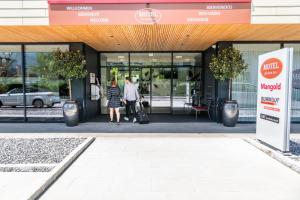 two people walking out of a mcdonalds building at Motel Keckeis Inn - Self Check-in in Sulz