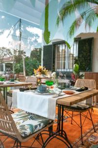 an outdoor table with chairs and a table with food on it at Hotel Boutique San Diego - Adults Only in Las Lagunas