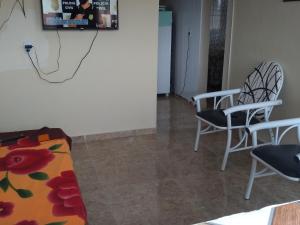 a living room with two chairs and a couch at Casa Bela Paisagem in Mucugê +3 photos