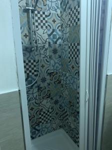 a shower with a glass door in a bathroom at B&B Corso Italia 58 in Orbetello +29 photos
