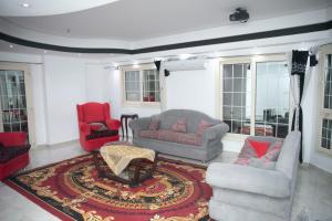 a living room with two couches and a rug at Luxury Apartments in Cairo