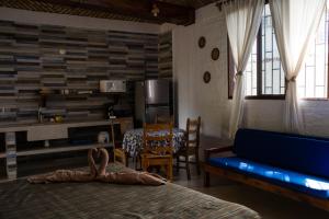 a bedroom with a bed and a table and a dining room at Las Casitas in Rincon de Guayabitos